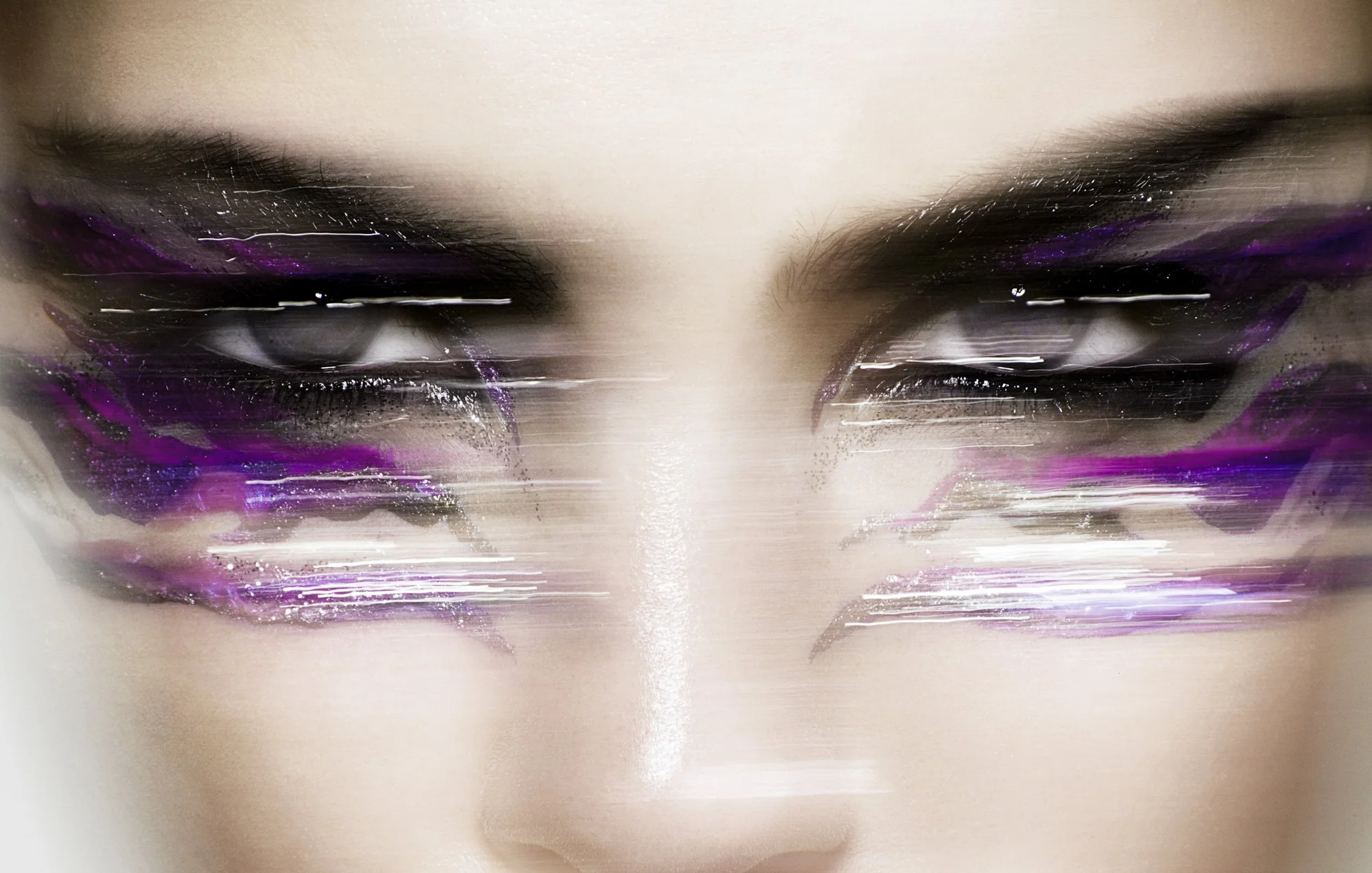 Close-up of a person's face with eye makeup, featuring purple and glitter eyeshadow, with a glitch effect.