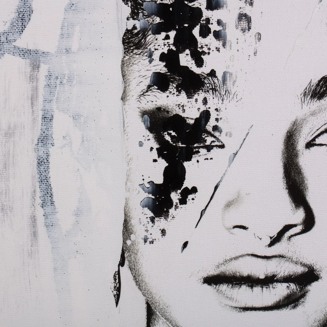 Close-up of a monochrome art piece portraying a woman's face, with abstract black ink splashes over the left side of her face.