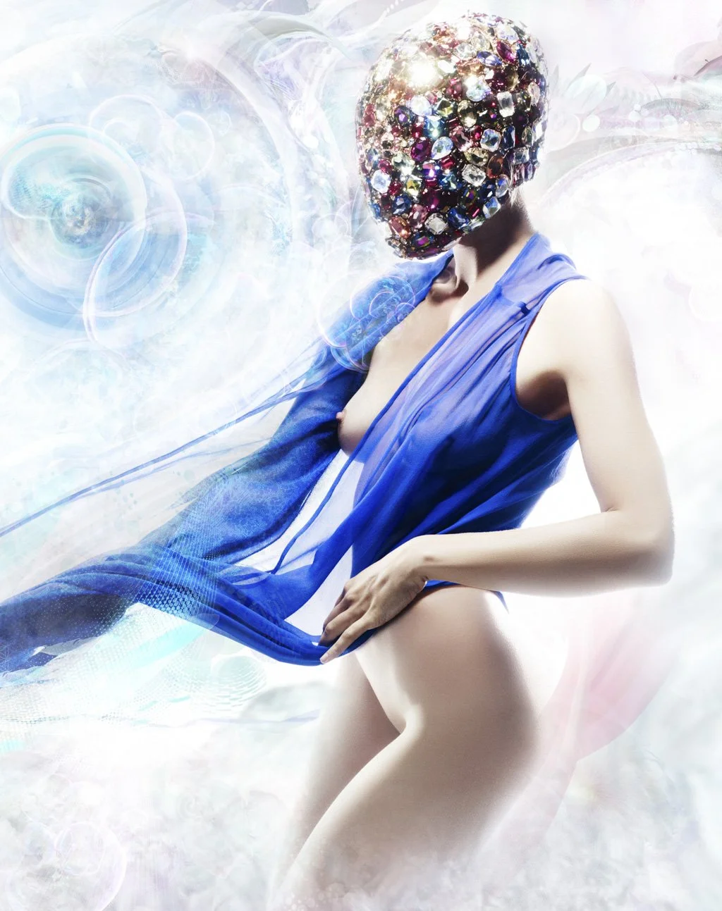 A person with a faceless head covered in multicolored jewels, wearing a blue sleeveless cover-up, posed against a surreal, luminous background with swirling patterns and abstract light effects.