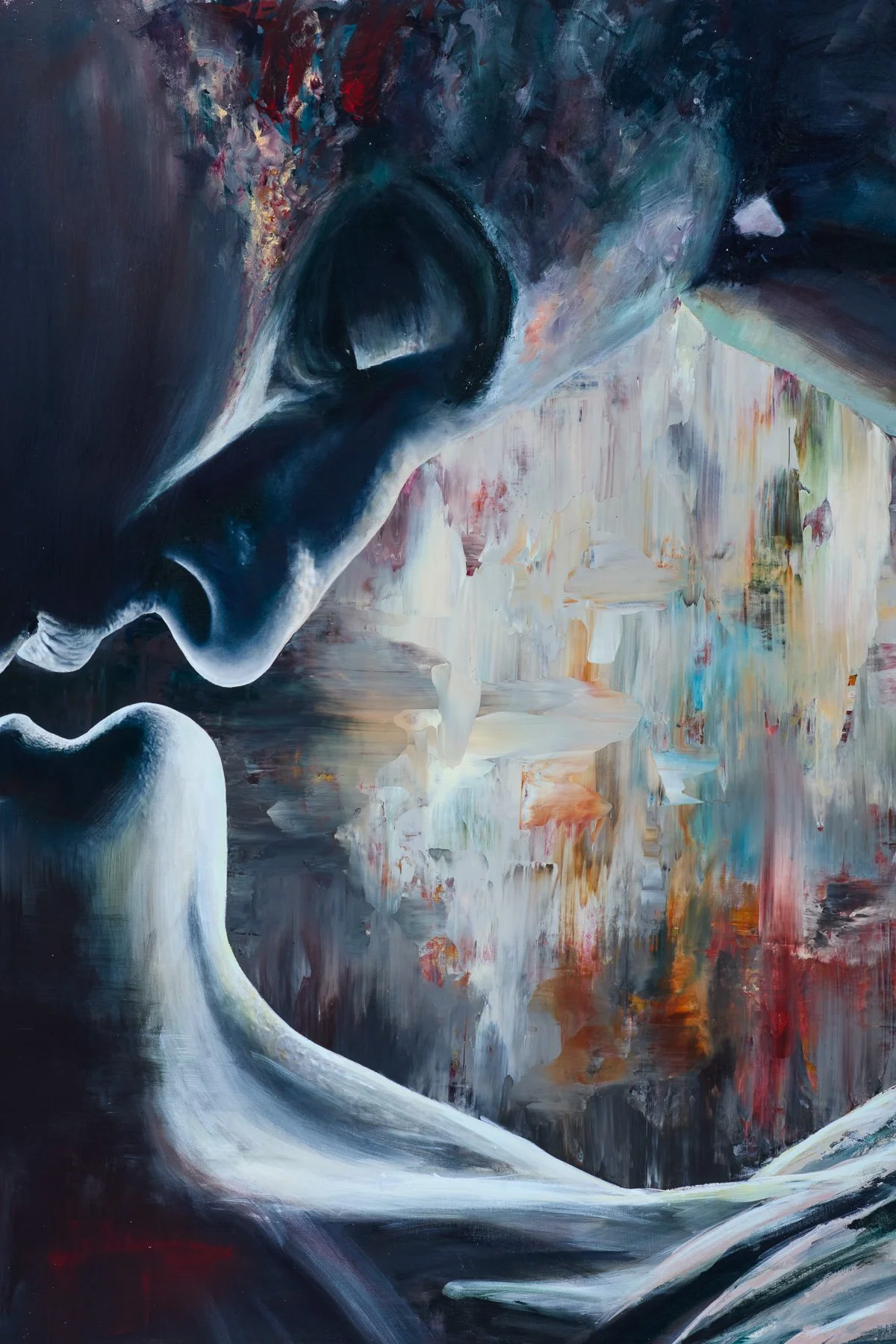 Close-up of a person with glasses, looking down in a reflective pose, with an abstract, colorful background.