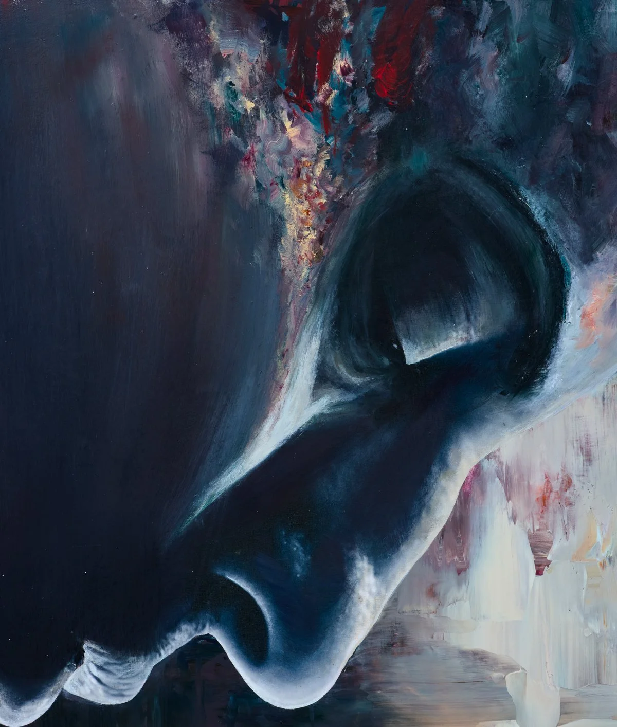 A close-up of an abstract painting depicting a stylized face with dark and light tones, and colorful brushstrokes at the top.