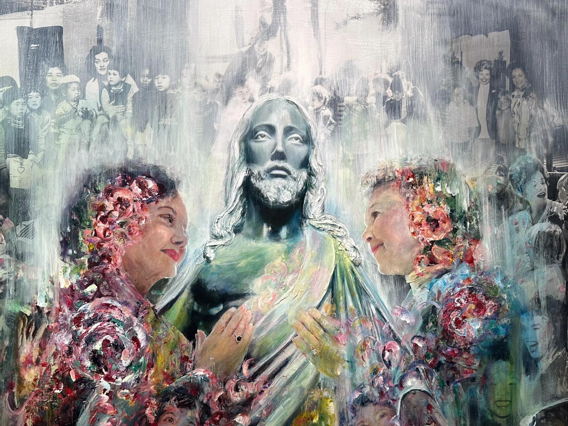 A mural depicting Jesus Christ with two women, surrounded by smaller images of people, some with flowers in their hair, and various other faces in the background.