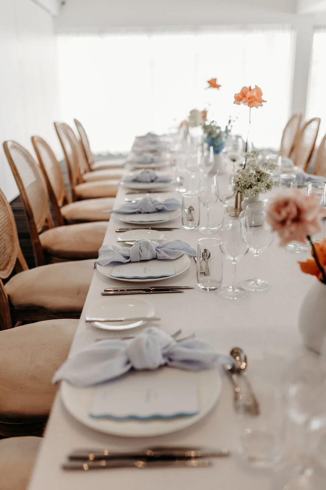 wedding reception styled in blue, peach and white tones