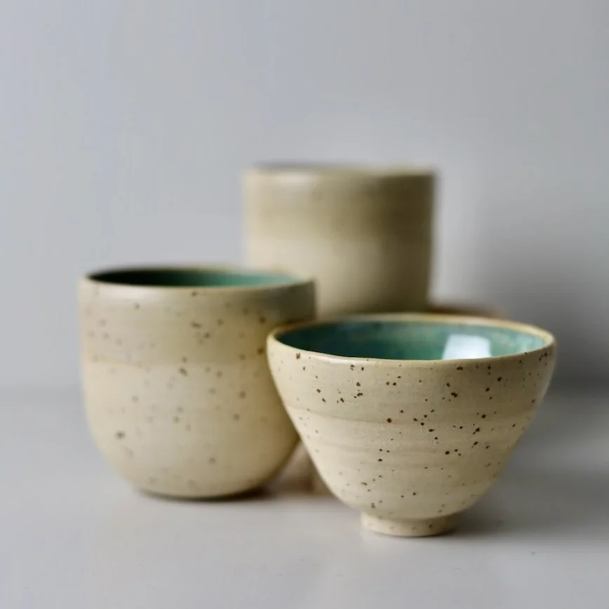 Speckled ceramic cup with saucer