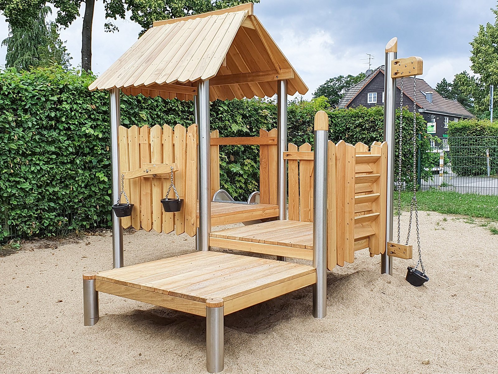 Compact roofed playground set with slide for young children, designed for public outdoor areas and compliant with EN 1176 safety standards.