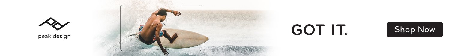 A man surfing on a wave, with advertising text for Peak Design and a "Shop Now" button.