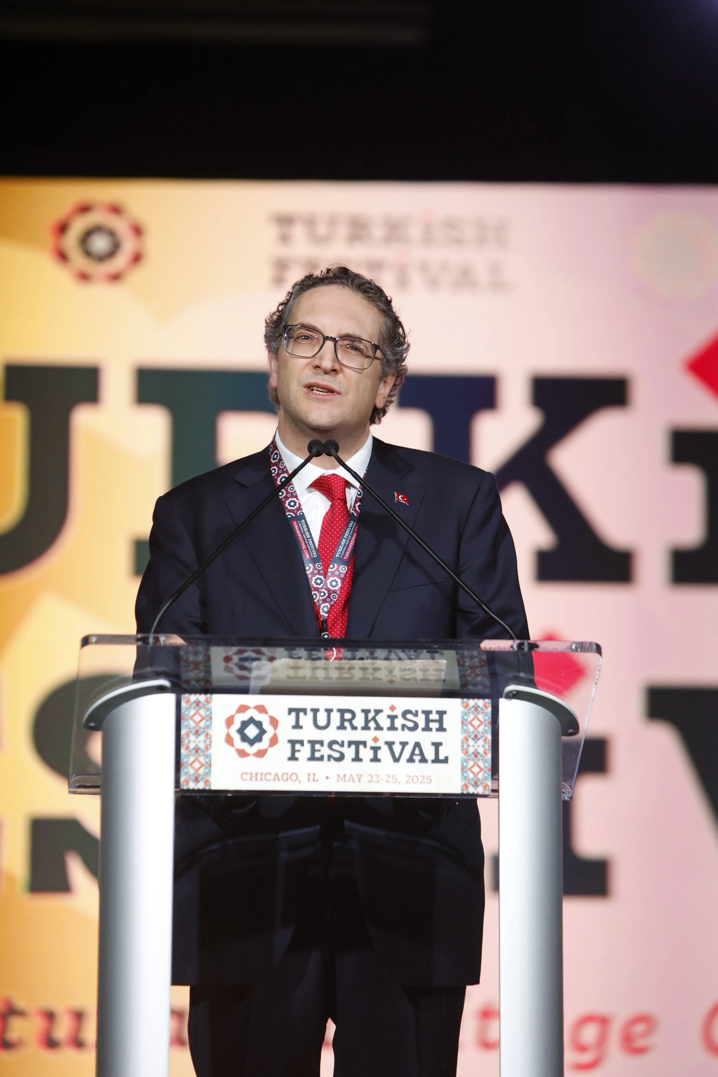 A man in glasses and a suit speaking at a podium during the Turkish Festival in Chicago, Illinois, May 23-25, 2025.
