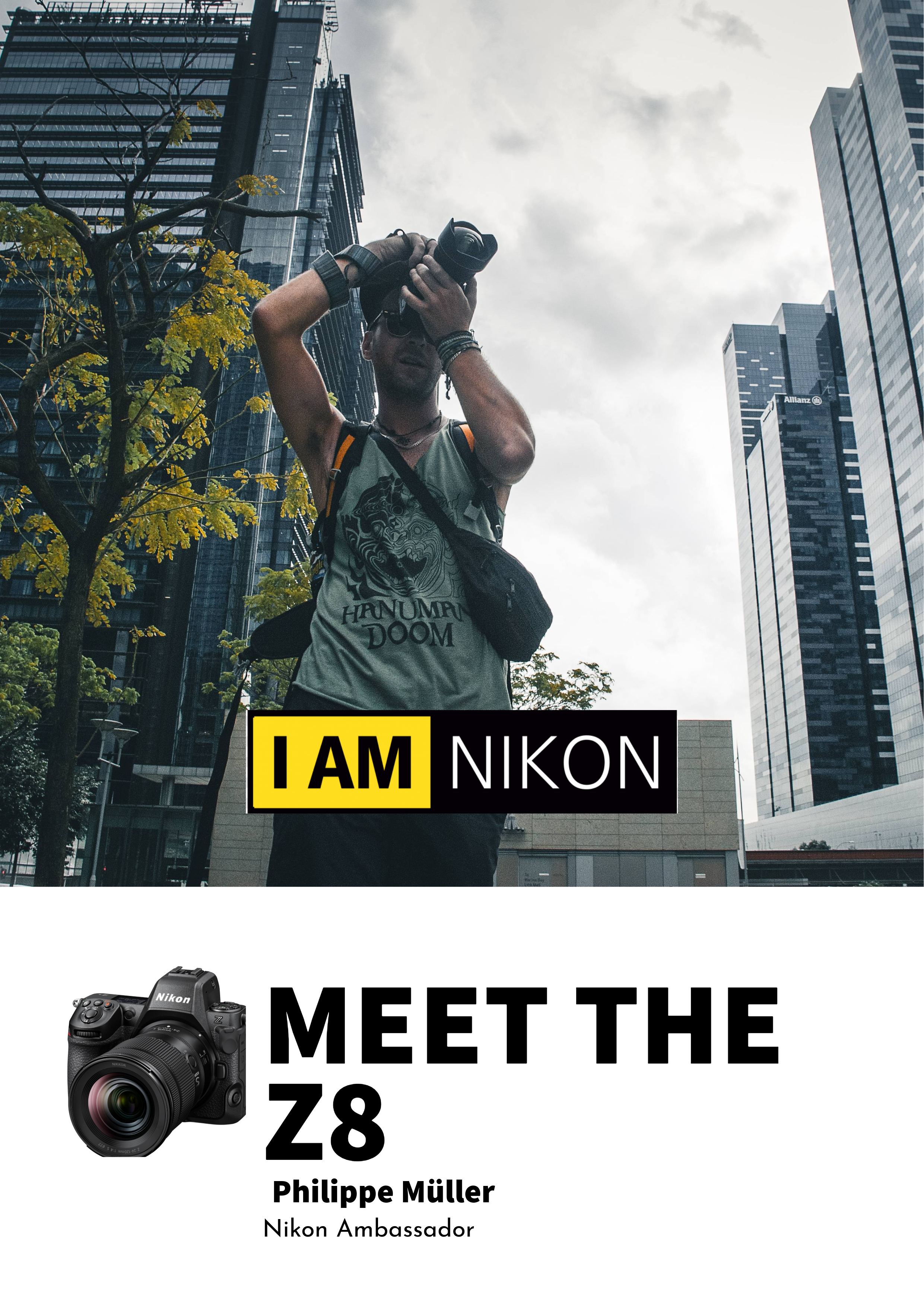 Ein junger Mann fotografiert mit einer Kamera in einer urbanen Umgebung mit Hochhäusern und einem bewölkten Himmel im Hintergrund. Er trägt ein T-Shirt mit dem Text "HANUMAN DOOM".