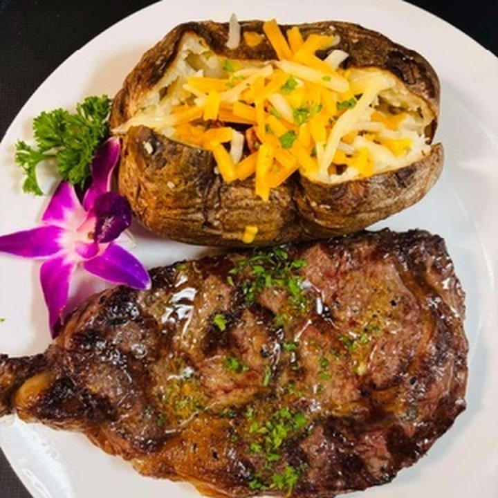 Ribeye with a loaded baked potato
