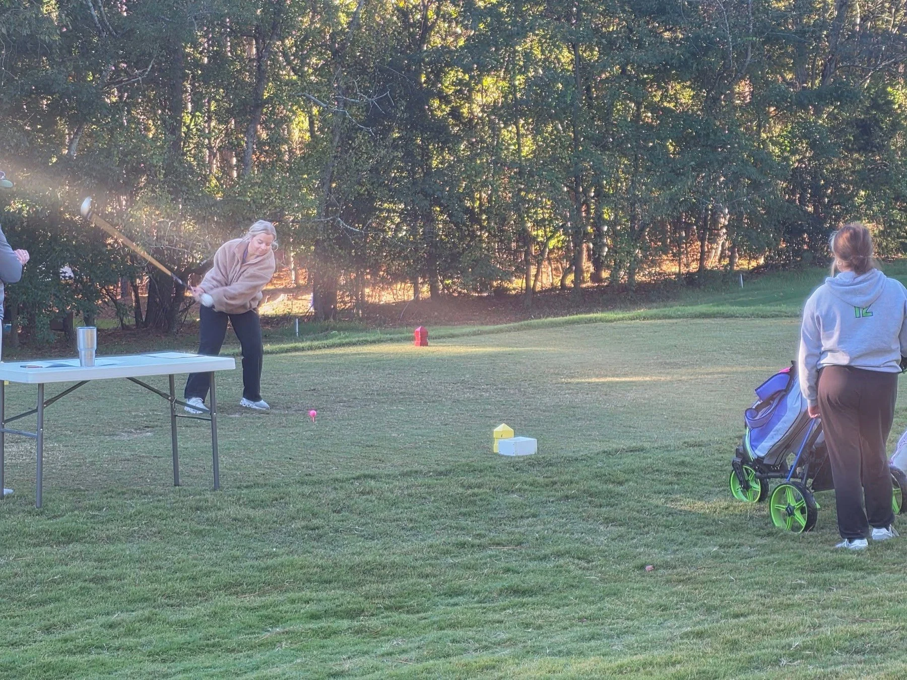 Golfers warming up before the NCHSAA 3A Women's Regional at Seven Lakes