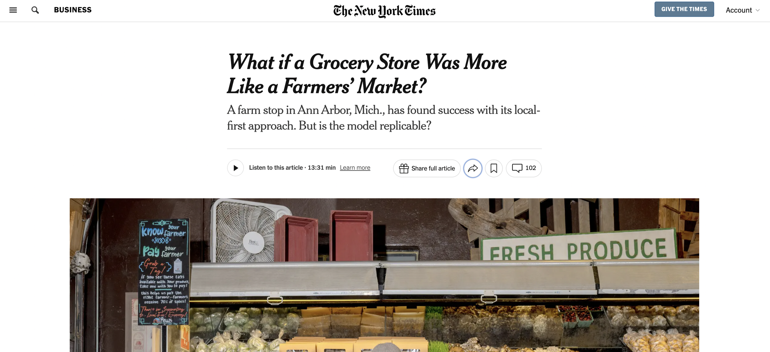 Inside a grocery store, a sign reading 'FRESH PRODUCE' is visible above a display of fruits and vegetables.