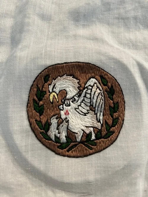 Commissioned combined Pelican and Laurel badge embroidered in silk using split stitch.