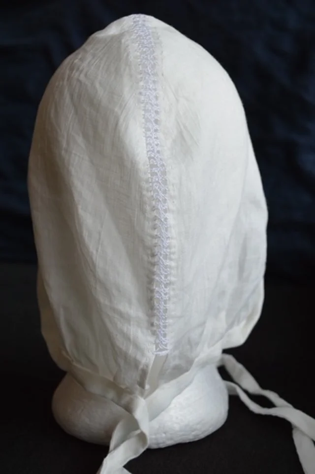 St Birgitta’s cap constructed in linen with hand-worked seams and herringbone stitching.