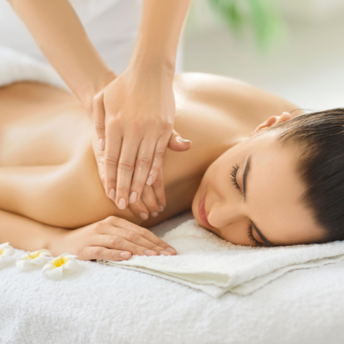 Woman receiving a back massage in a spa or massage therapy setting.