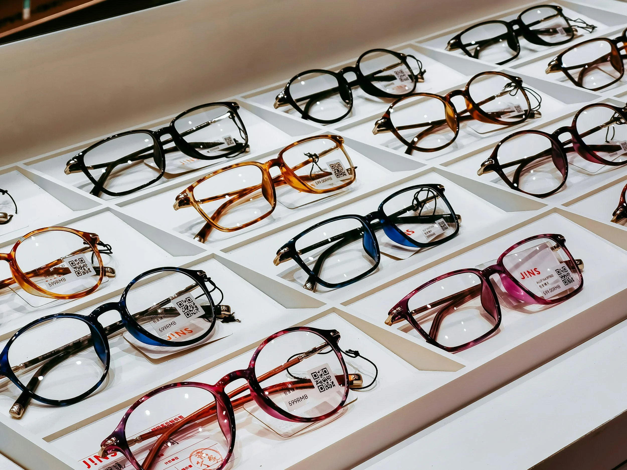 Selection of colorful eyeglass frames available for custom prescription lenses at a Nigerian eye care clinic. Omnivision