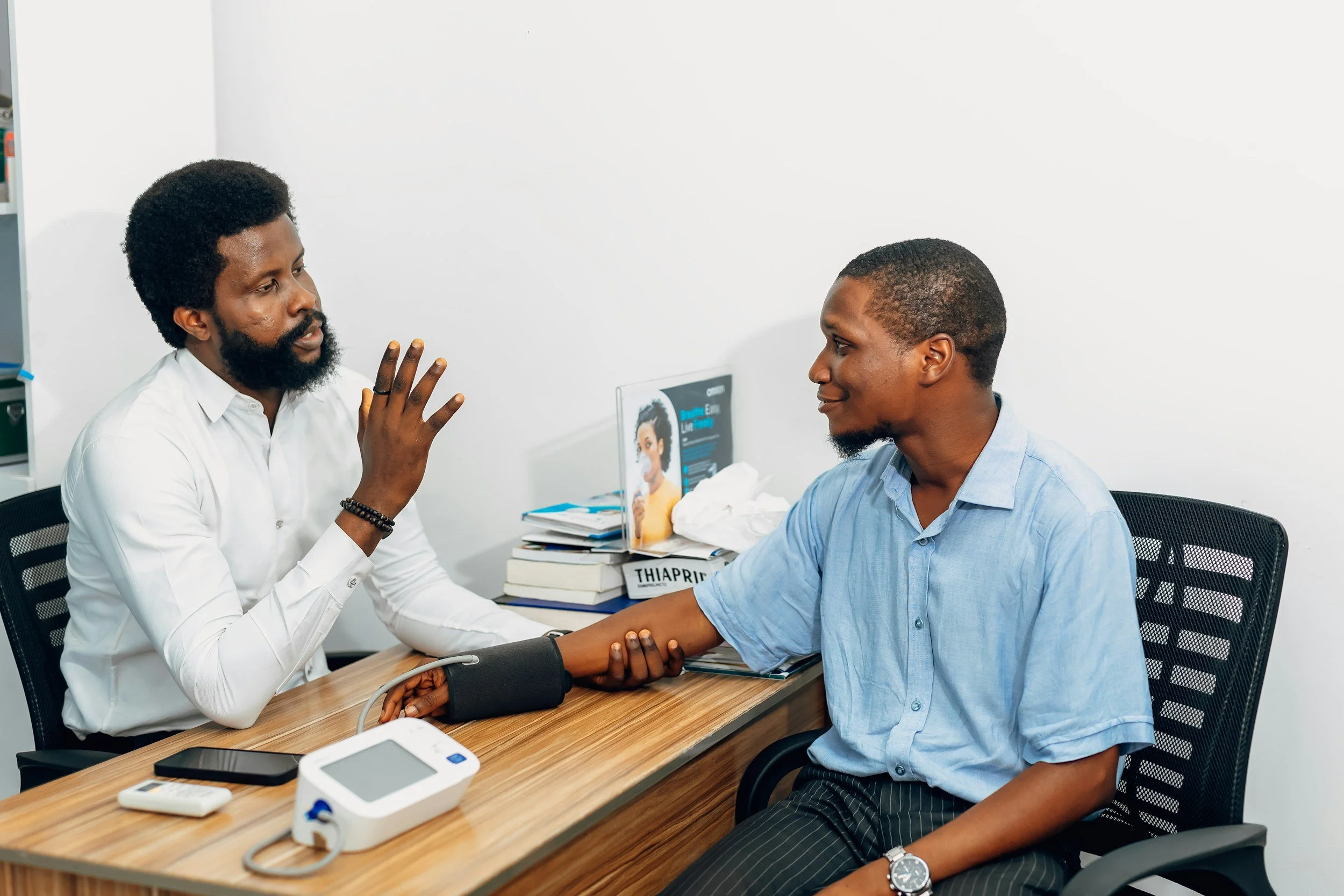 Physician consulting with a patient about eye health and treatment options at an ophthalmology practice in Nigeria
