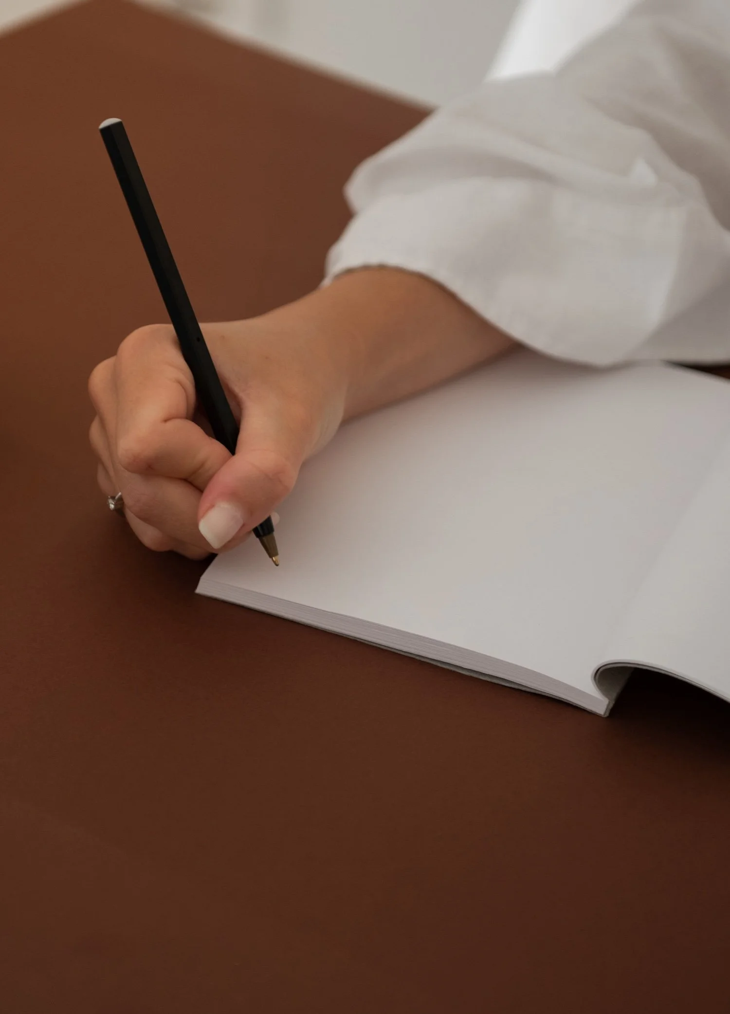 woman writing on diary