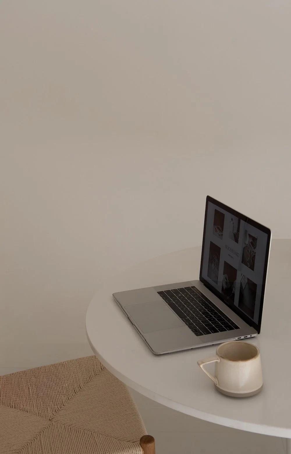 laptop on desk with mug