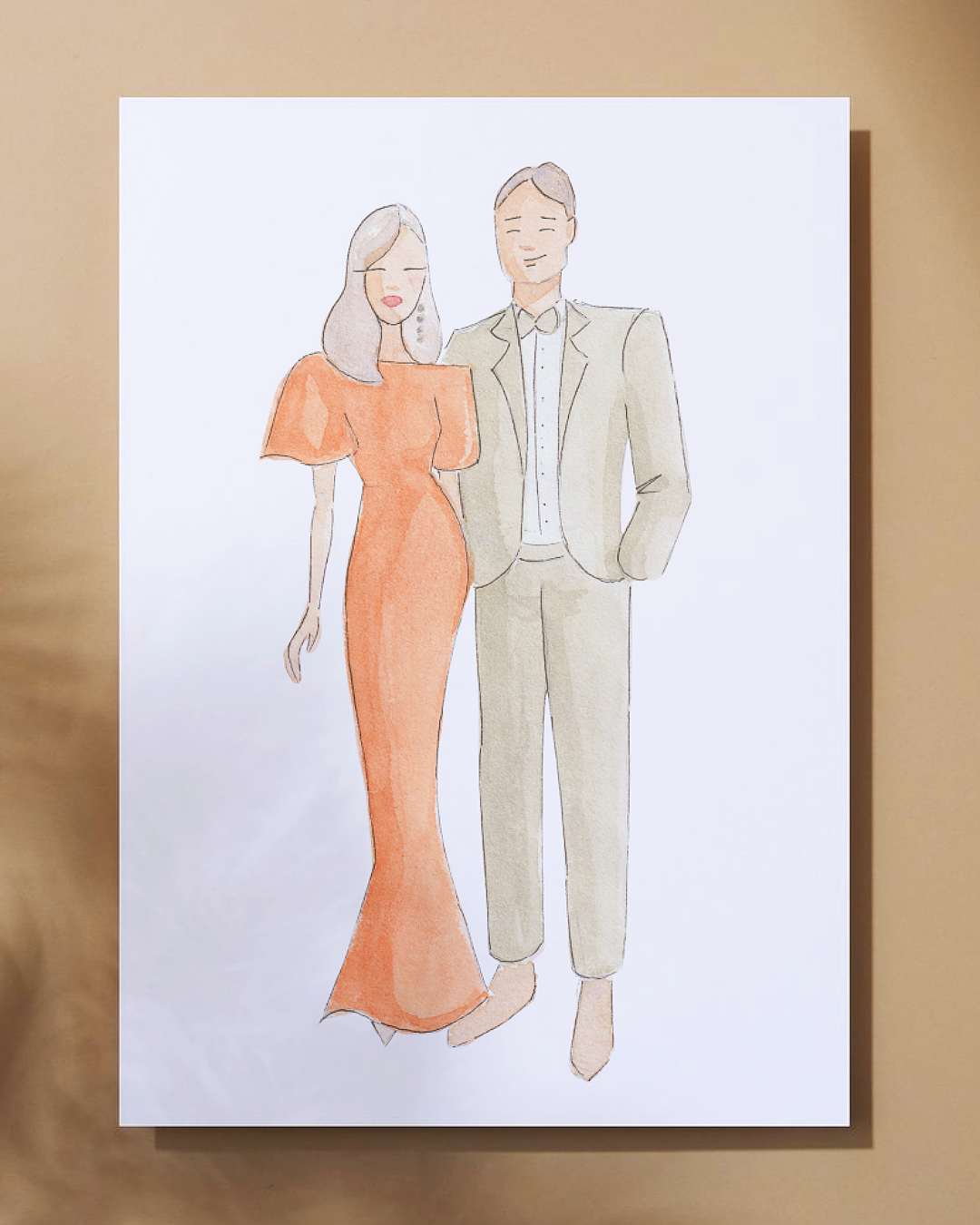 A watercolor illustration of a man and woman standing together, dressed elegantly. The woman is wearing a long orange dress with puffed sleeves, and the man is in a light-colored suit with an open-collared shirt. They appear to be smiling.