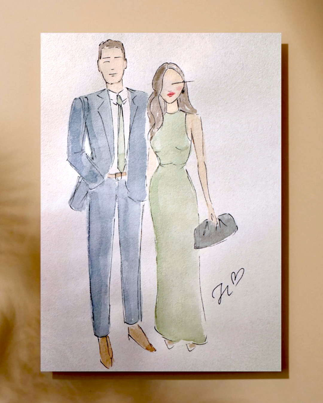 Watercolor illustration of a man in a blue suit and a woman in a green dress, holding a gray purse, with a heart and initials 'J L' at the bottom right.