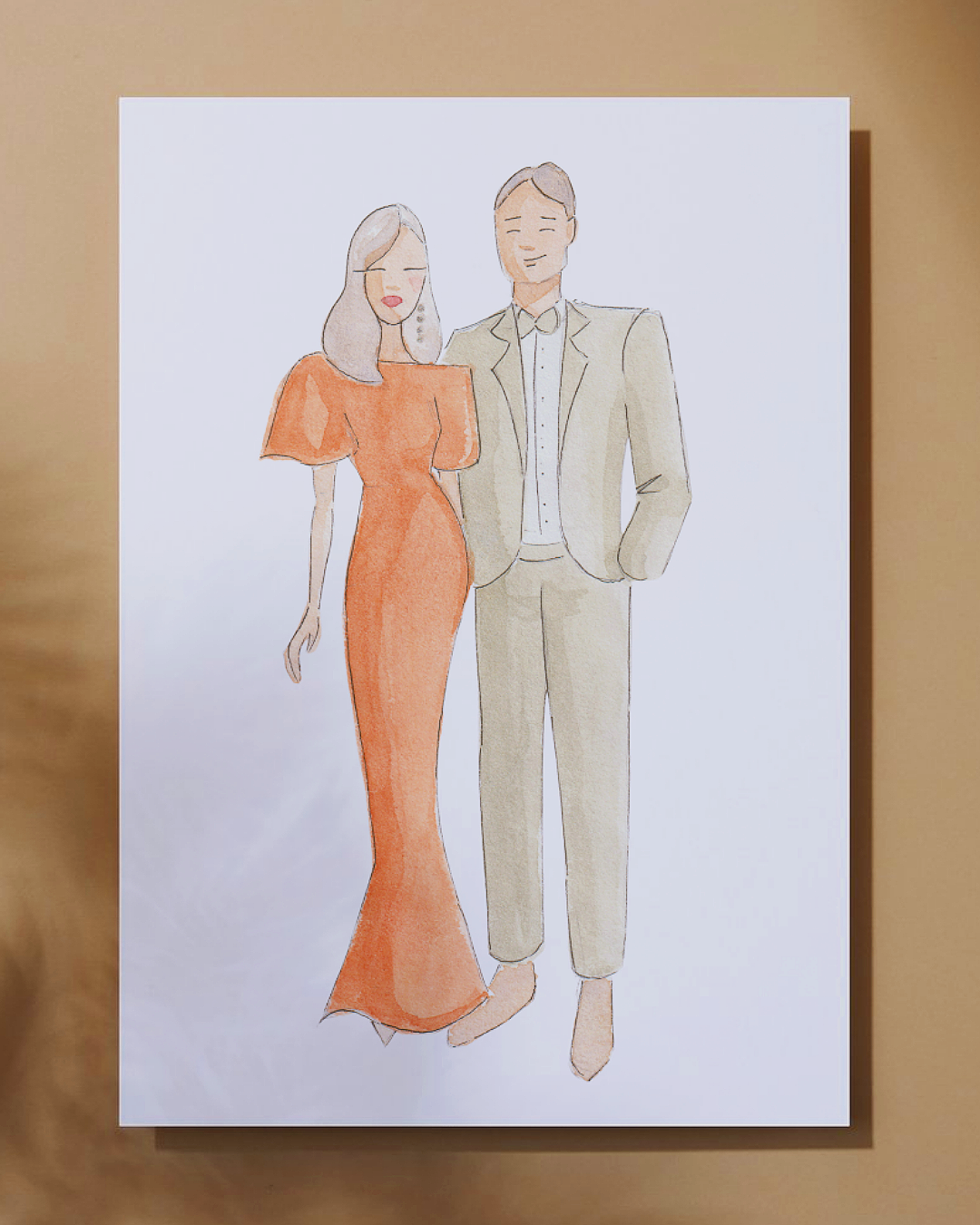 Watercolor illustration of a smiling woman in an orange dress and a man in a light suit standing close together.