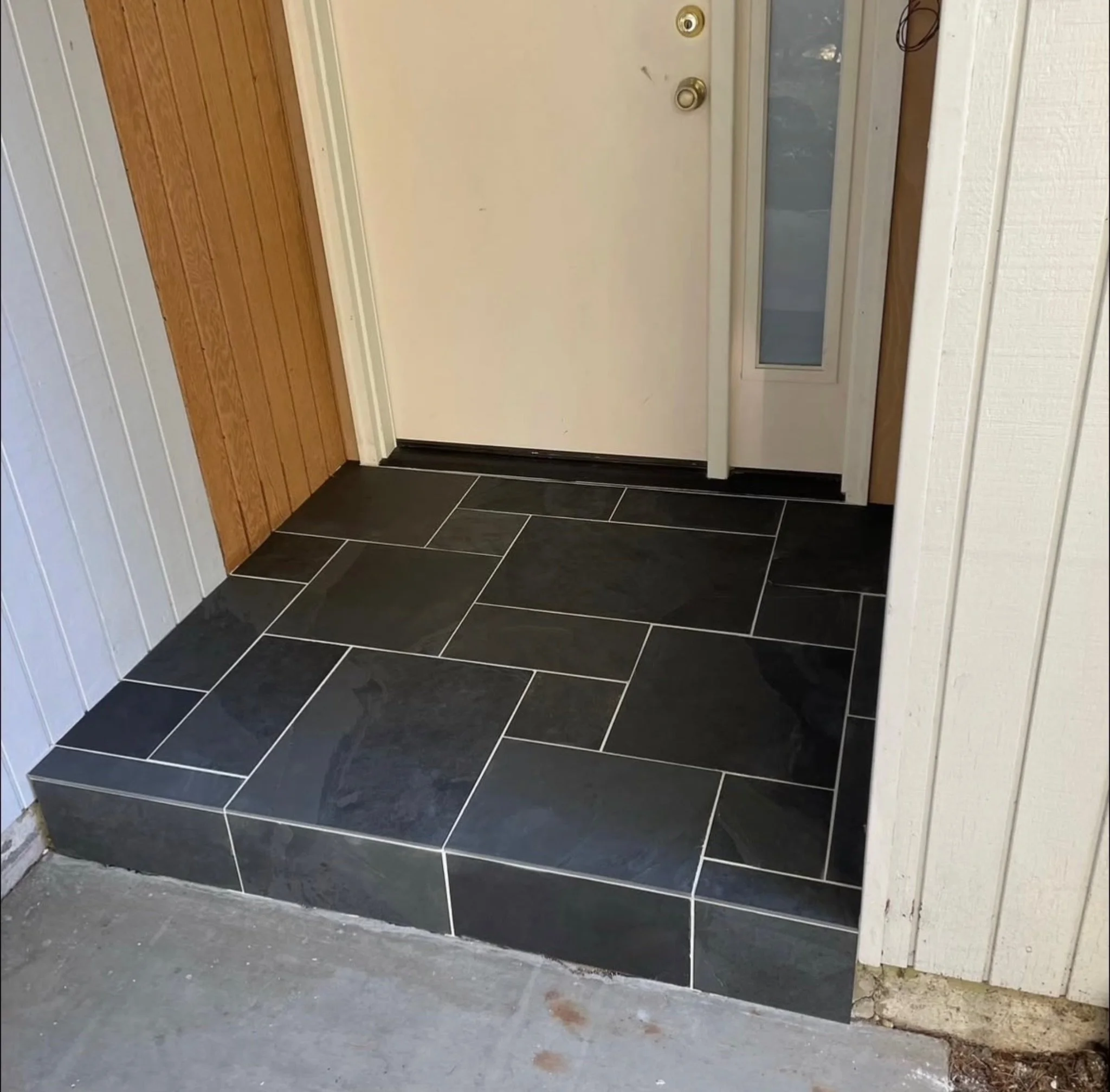 Slate tiles in Versailles pattern at entryway of a home.