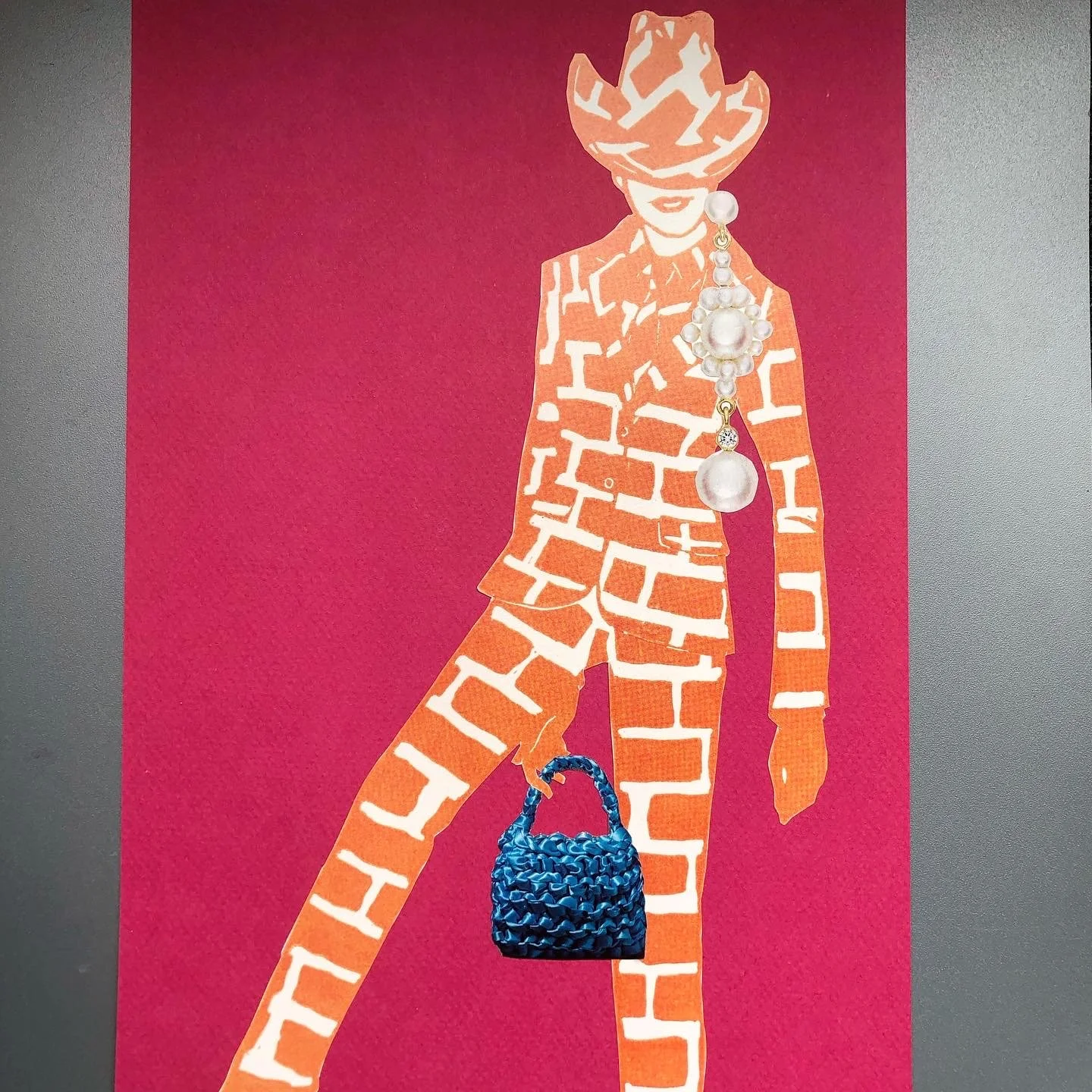 Fashion illustration of a woman wearing a brick-patterned suit and hat, holding a blue textured handbag, with a large pearl necklace.