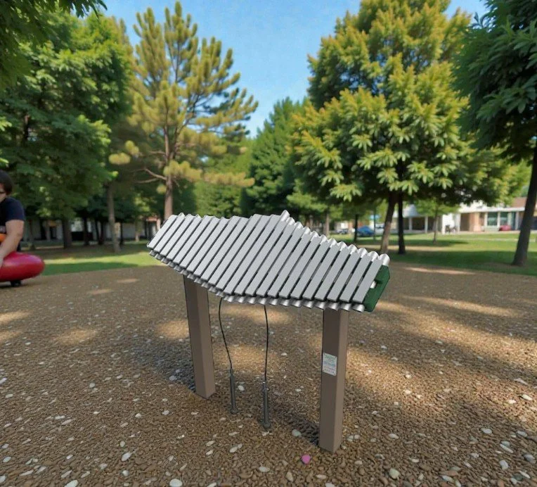 Metal xylophone on a stand in a park with trees and a blue sky in the background.