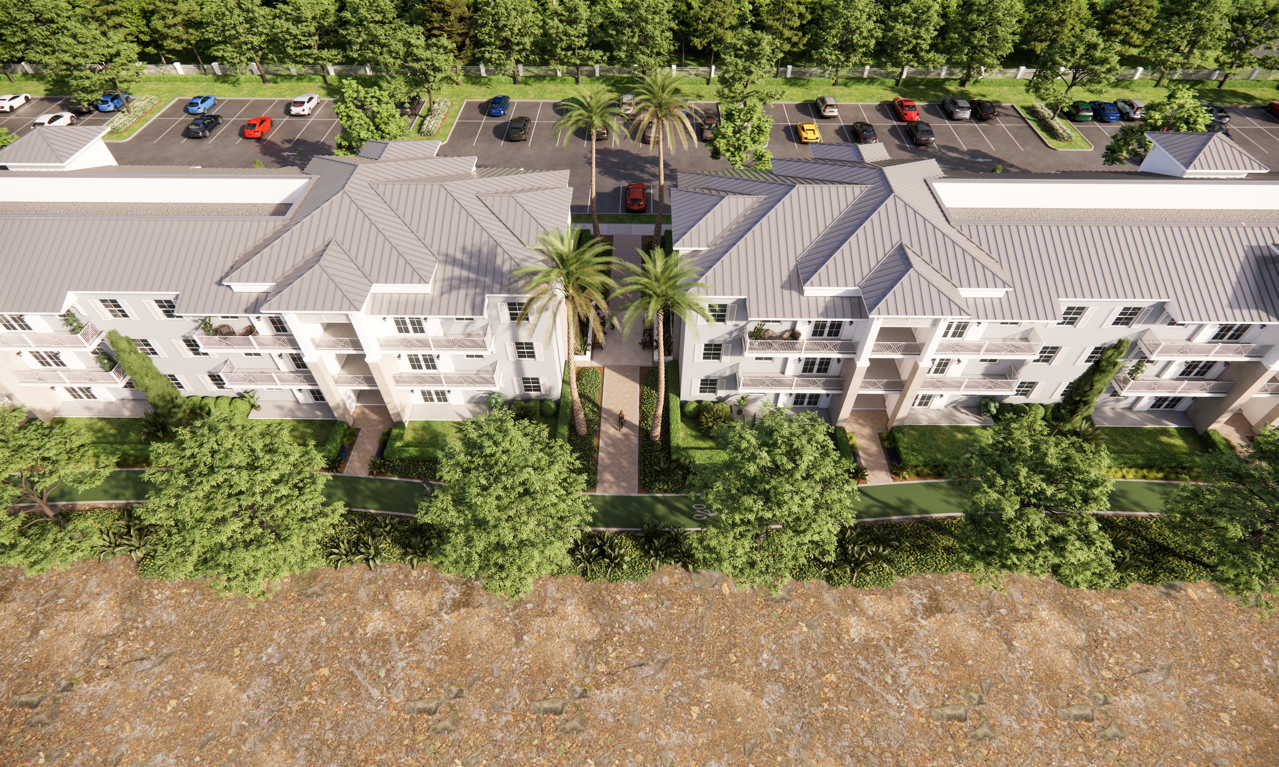 An aerial view of a modern apartment complex with white buildings, surrounded by lush green trees, landscaped gardens, and a parking lot with several parked cars.