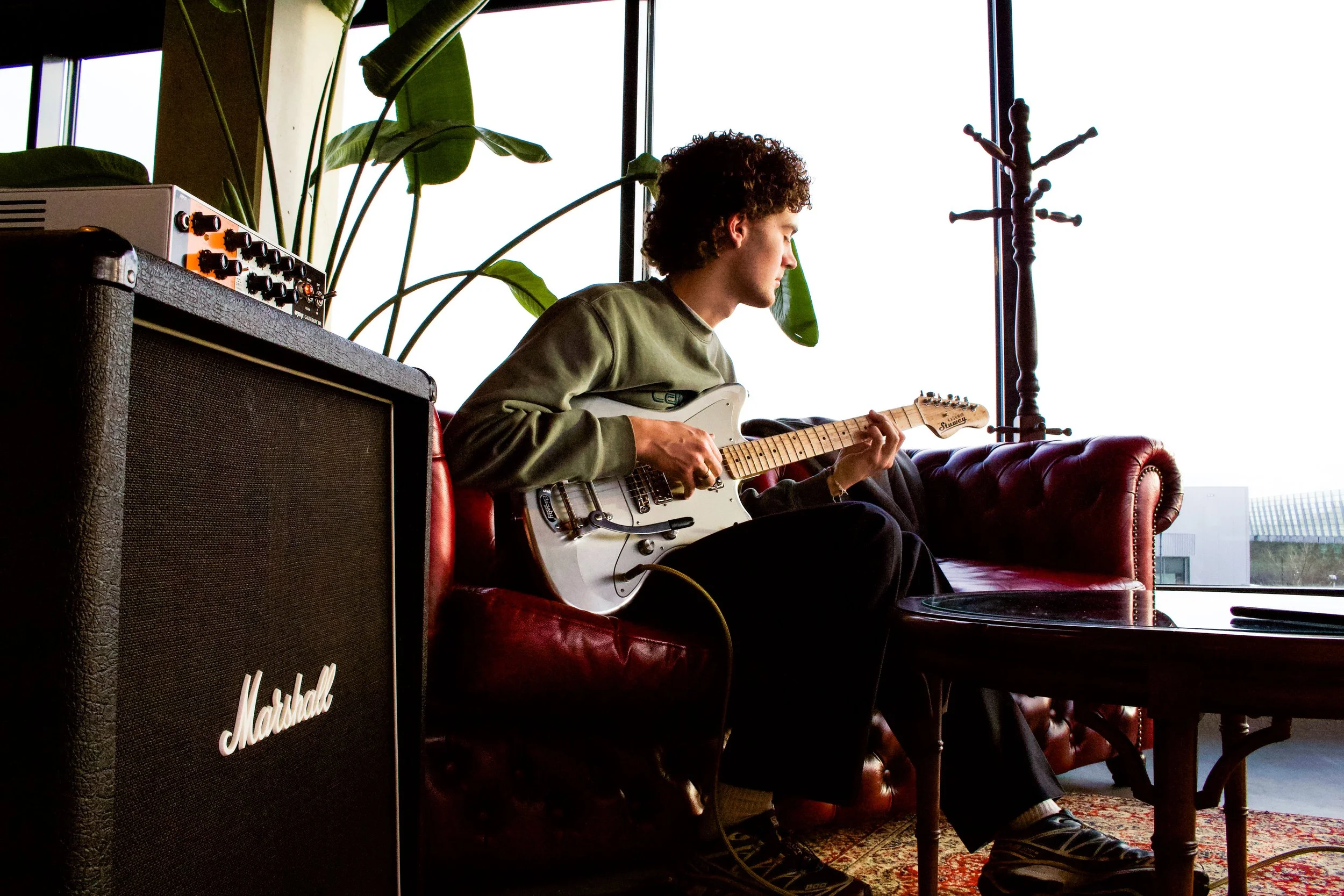Image of one of the owners playing the aluminium electric Kashmir guitar
