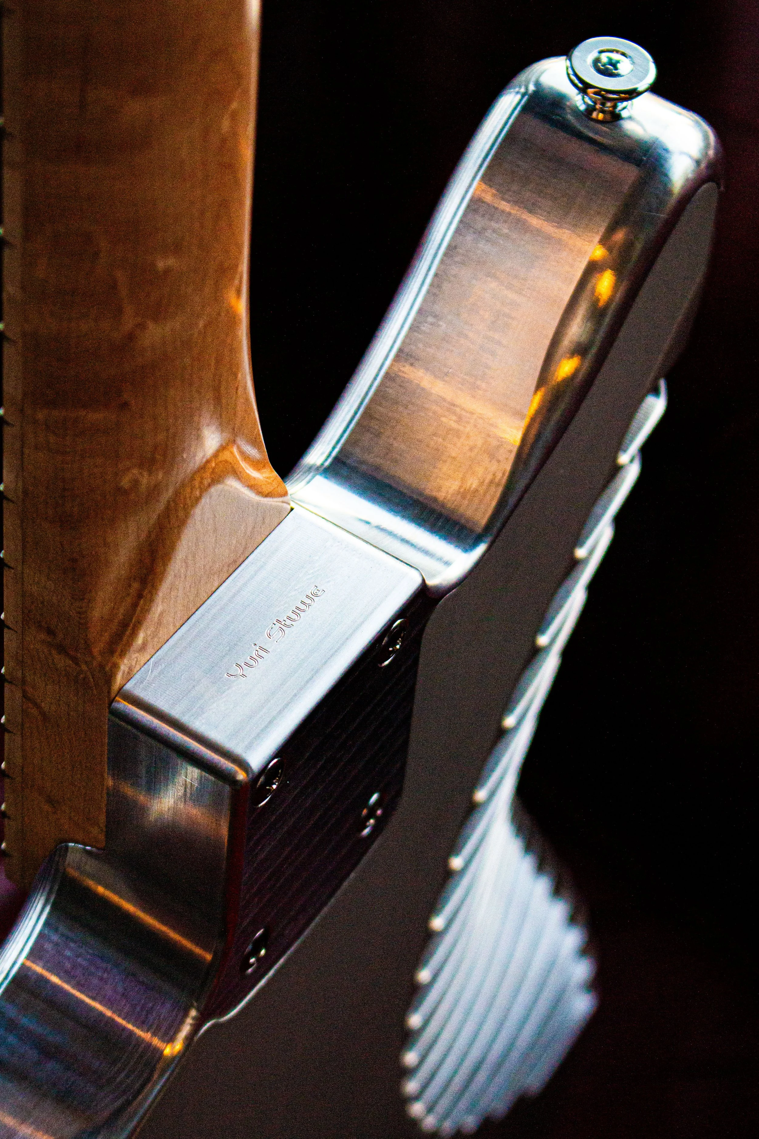 An image of name ingraving on the neck of the aluminium guitar