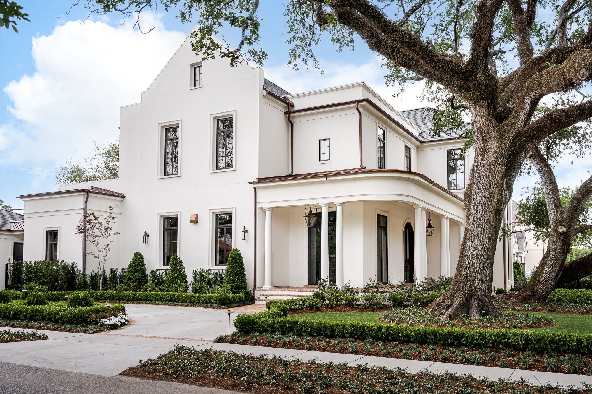 An image of the front yard and corner wrap-around front porch on the M Residence.