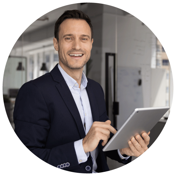Smiling male programme manager using a tablet for work