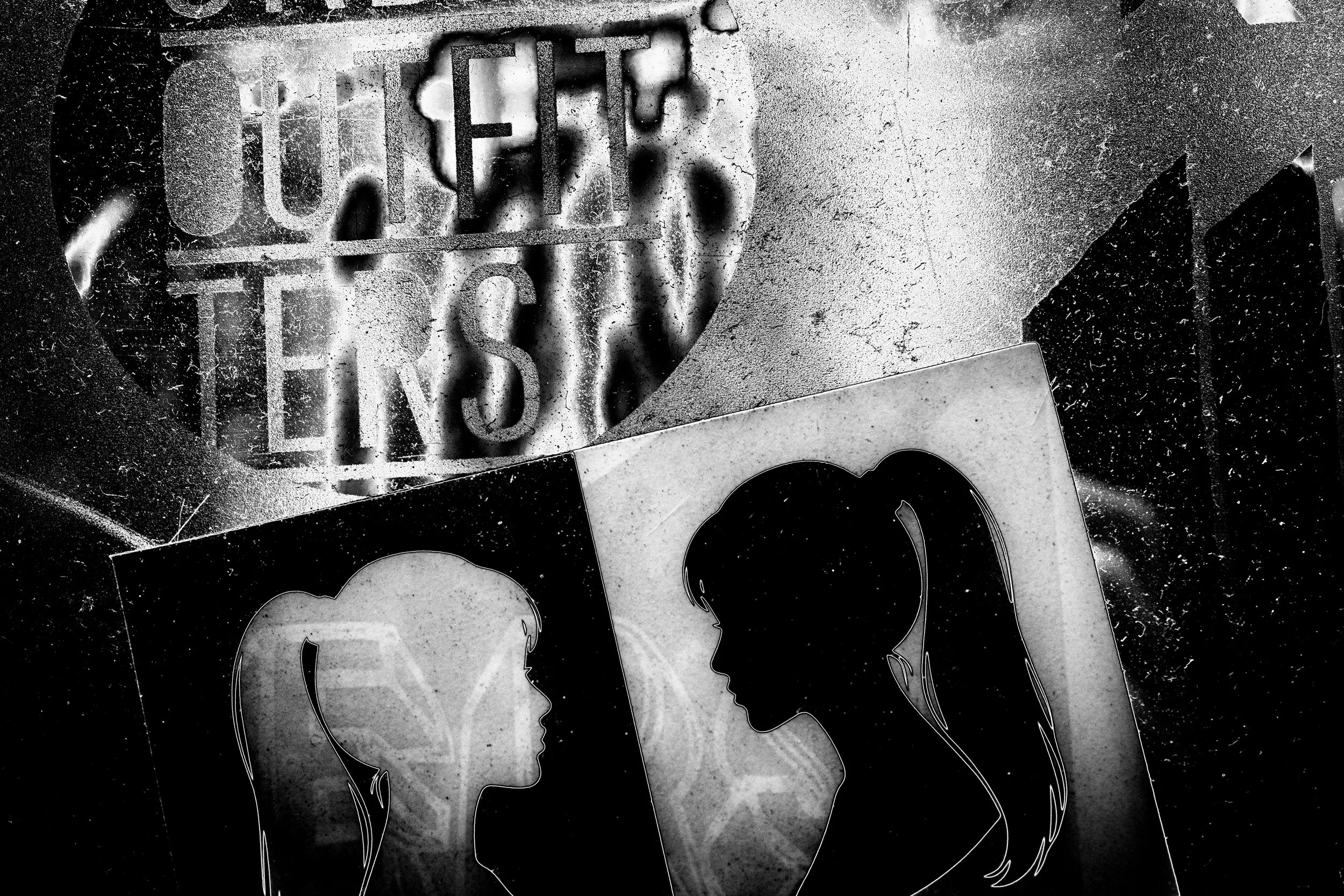 Street art stencil graffiti of two human profiles with ponytails, against a textured window, with spray paint markings.