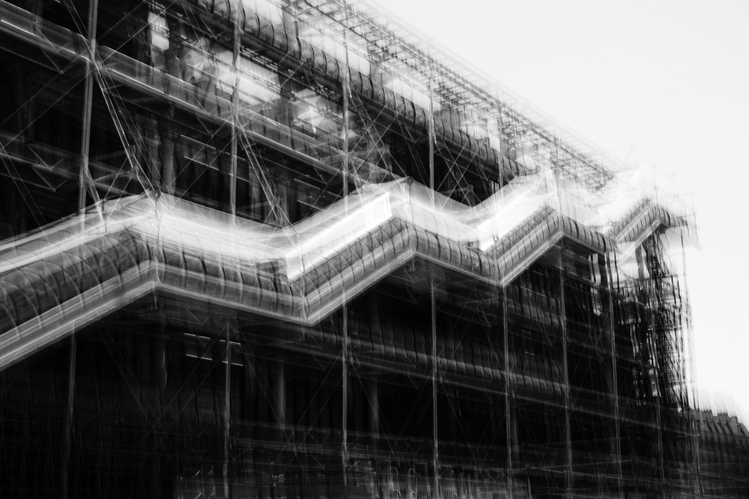 Black and white image with motion blur of the Centre Pompidou in Paris. 