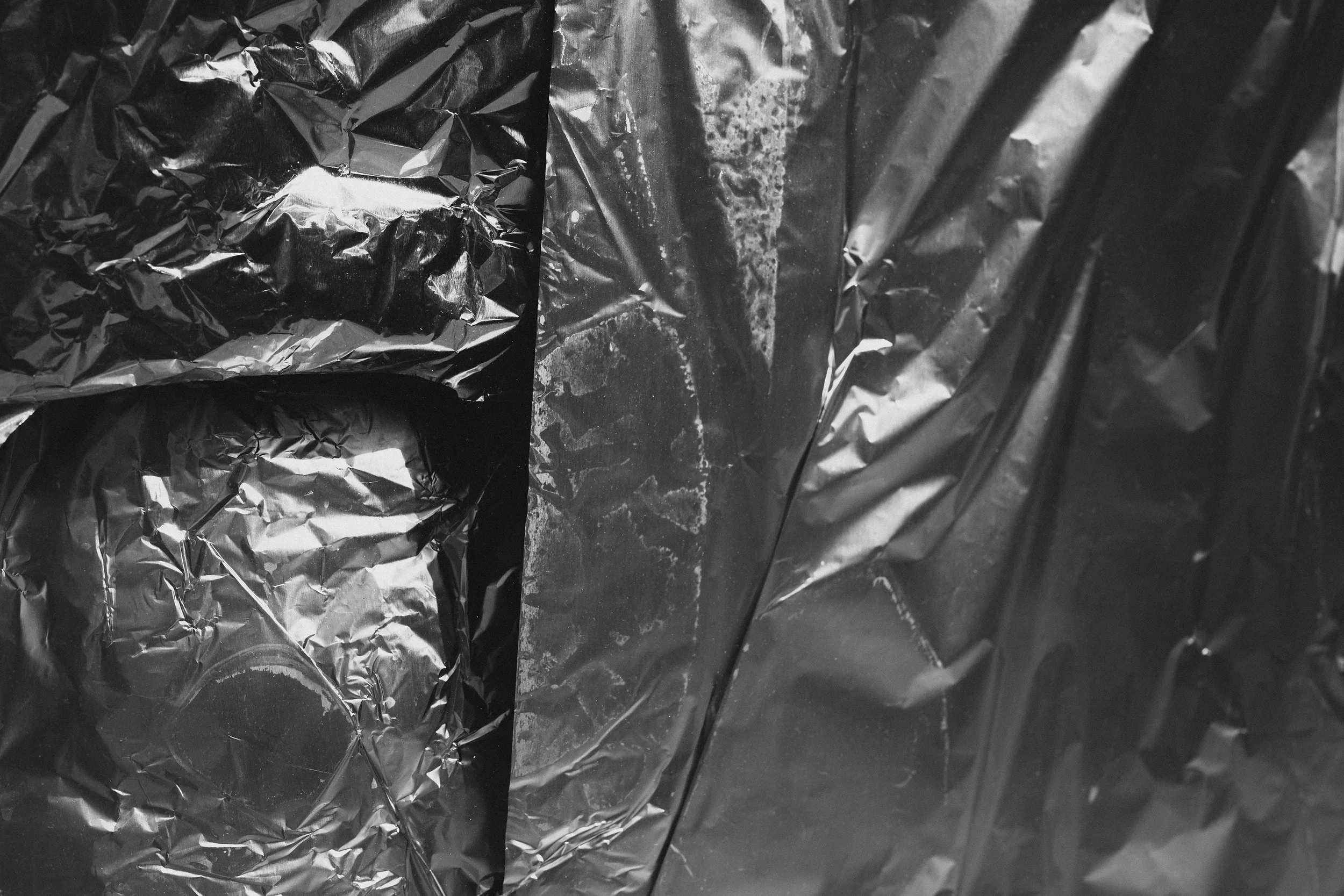 Close-up of crumpled black aluminum foil.