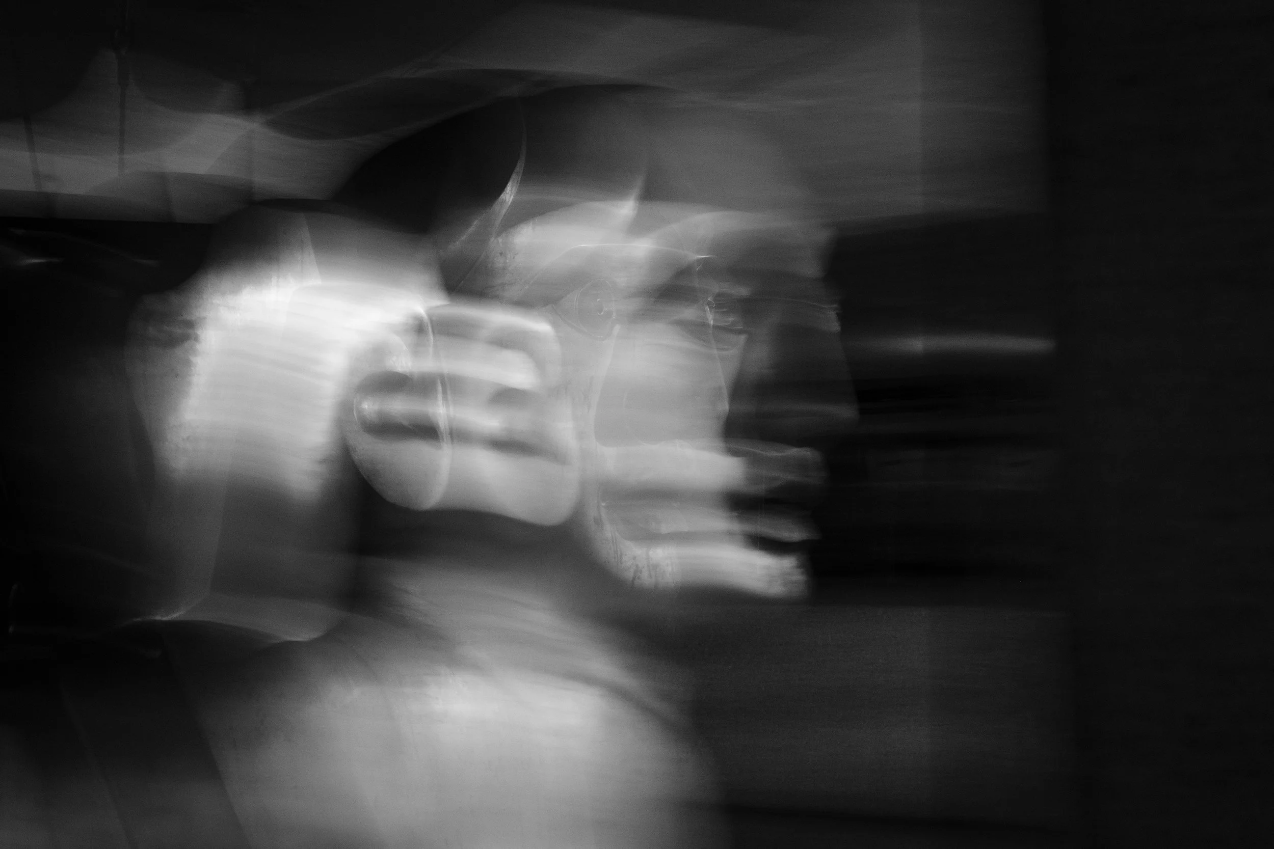 Abstract black-and-white photo with light streaks and blurred shapes, creating a dynamic and artistic visual effect.