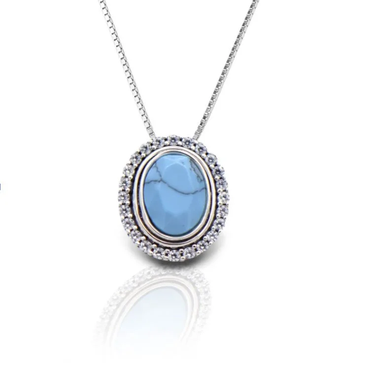 Beautiful Natural Turquoise pendant surrounded by diamonds in 14K white gold