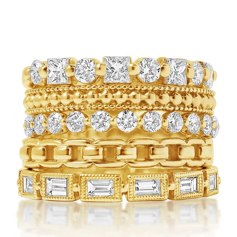 A stack of five gold rings, each decorated with diamonds in different settings and designs.