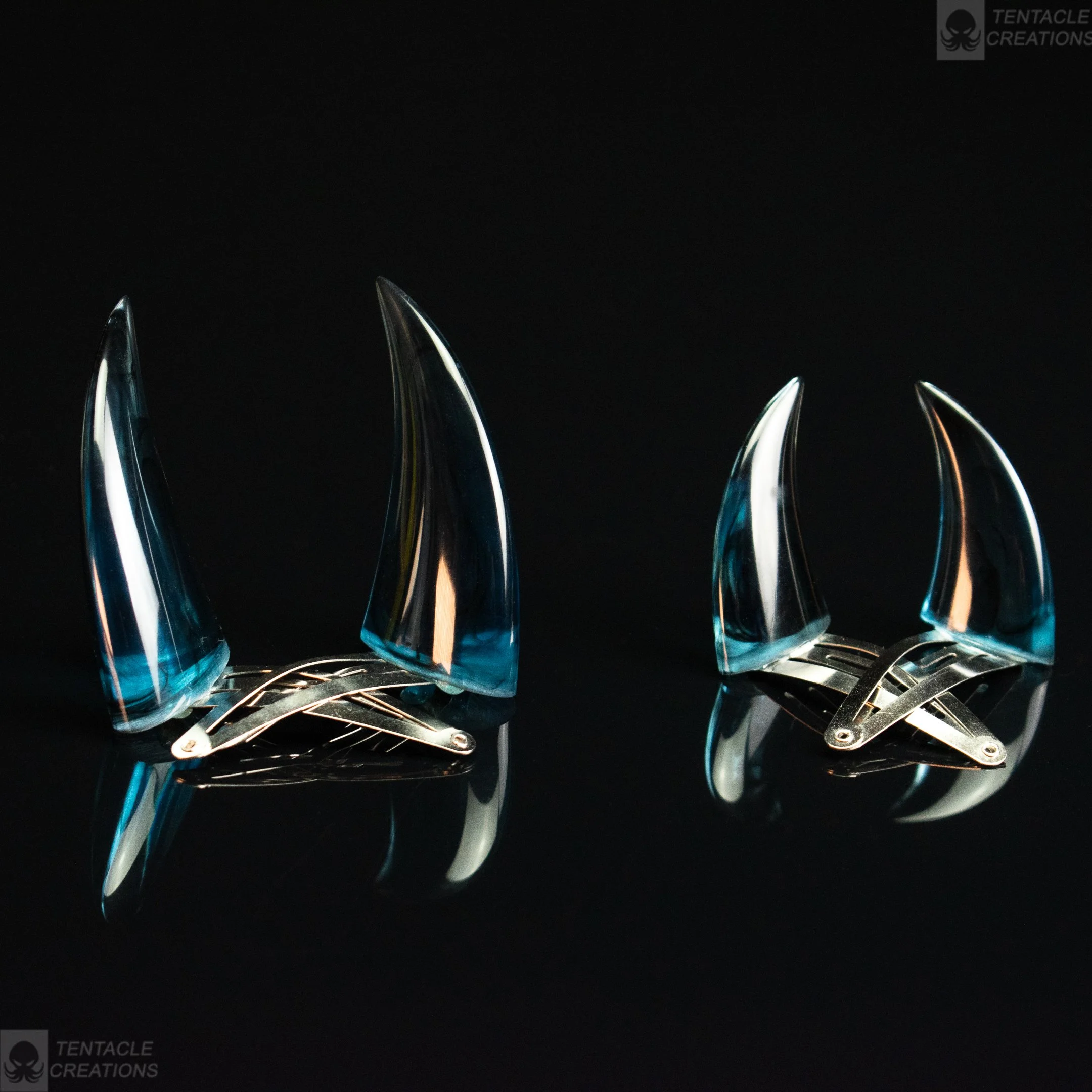 Horn hairclips - transparent blue with black swirls