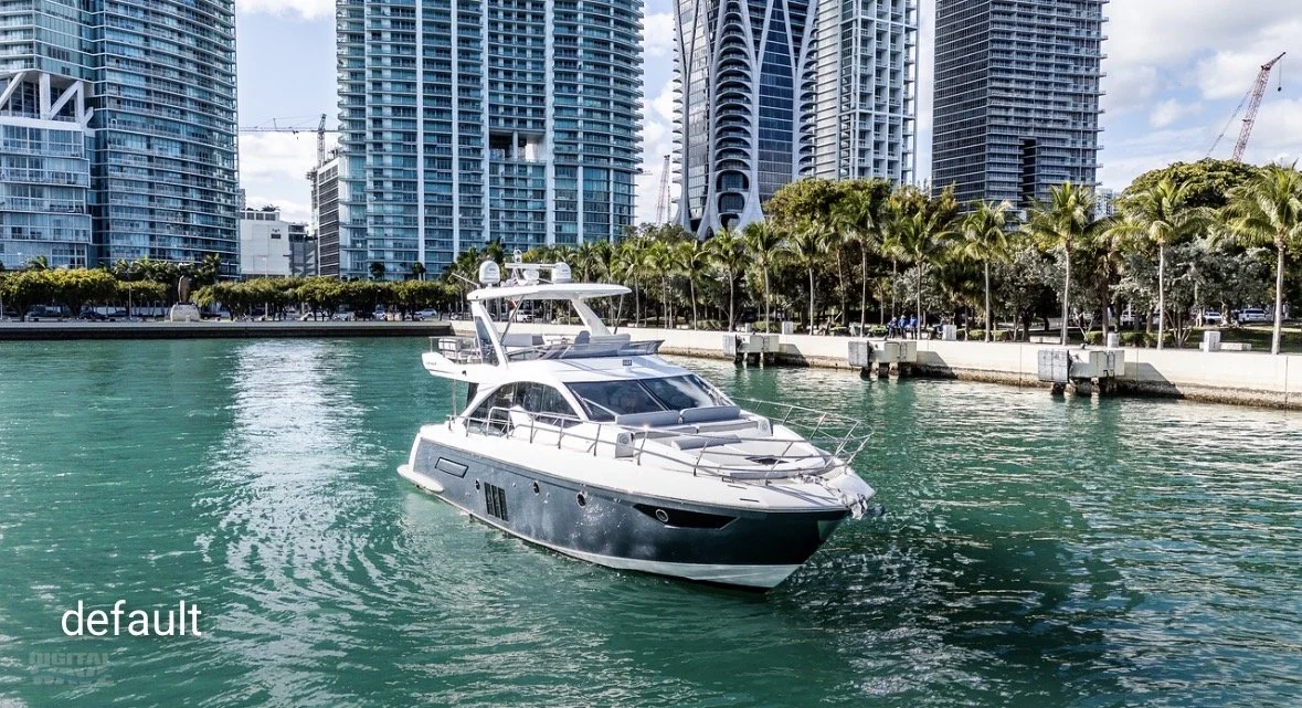 A white yacht boat sailing in a marina with urban high-rise buildings and palm trees in the background.