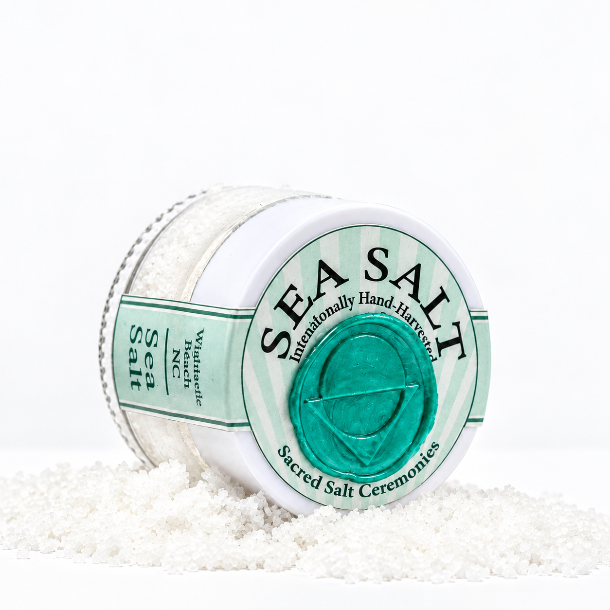 A container of Sacred Salt ceremonial sacred salt, with some spilled around it on a white surface.