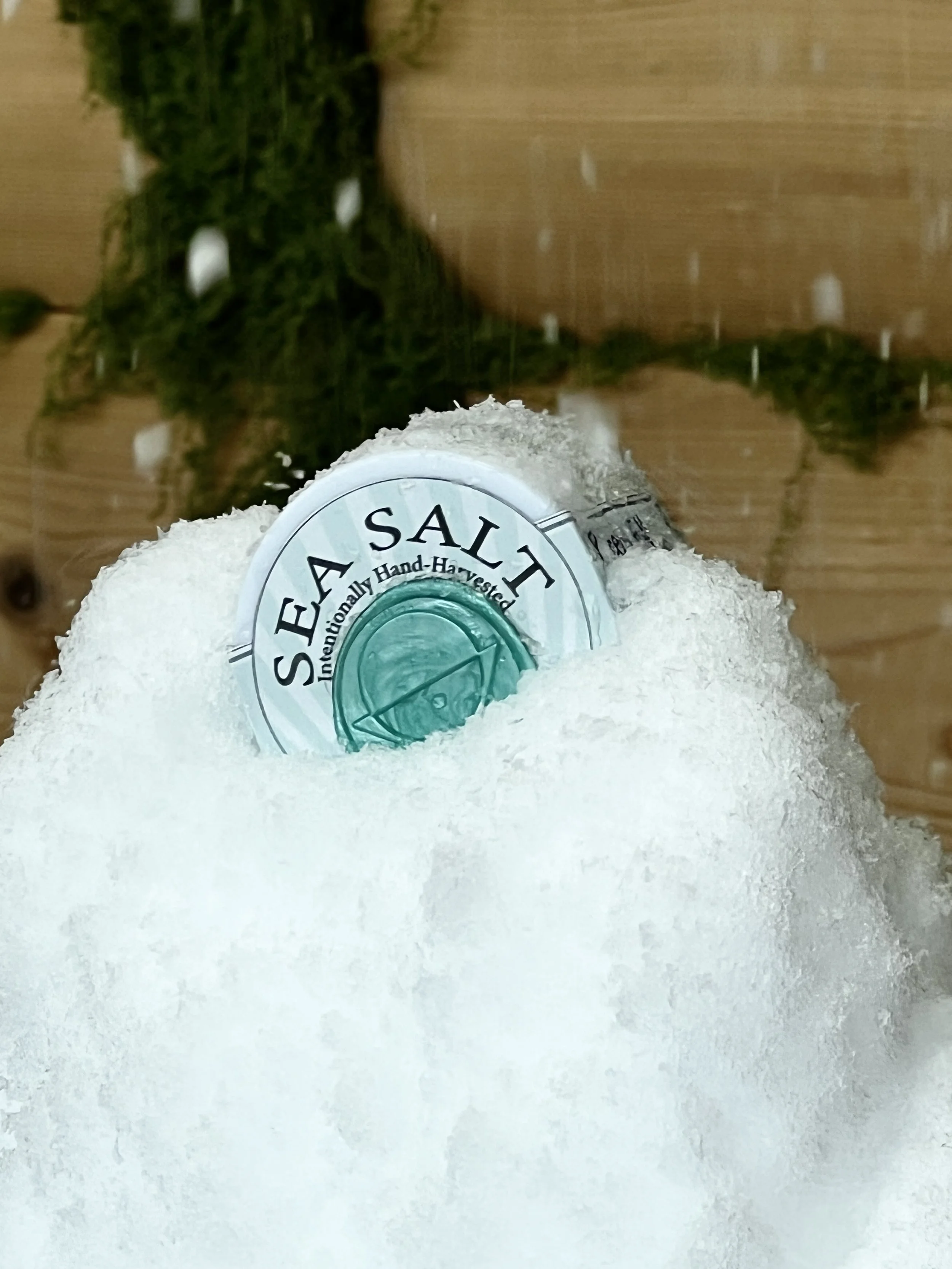 A container of sea salt with a label that reads 'Sea Salt: Traditionally Hand-Harvested.'