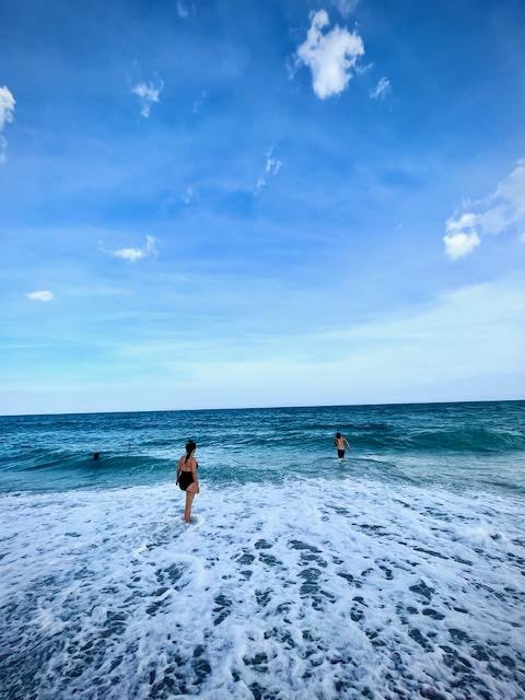 two people walking into a blue ocean