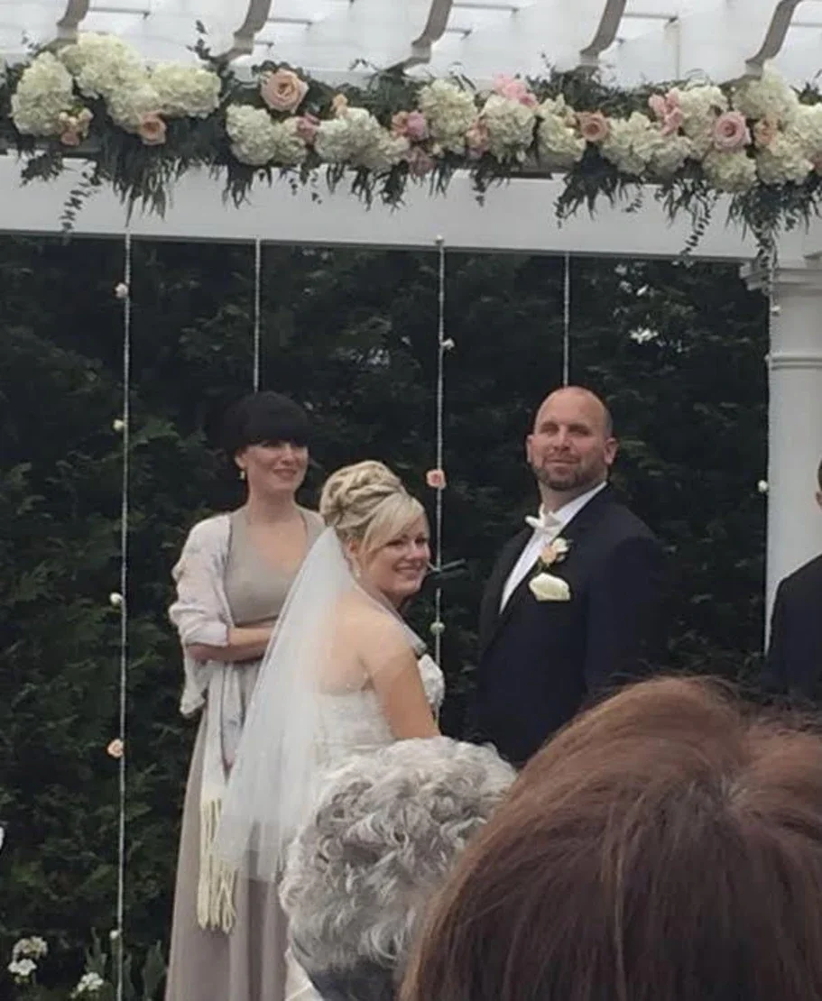 Wedding officiant with bride and groom