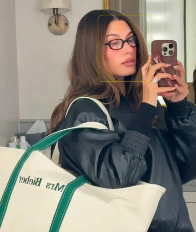 Hailey Bieber shut down speculation with a selfie featuring her L.L.Bean Boat and Tote, embroidered with “Mrs. Bieber”—a subtle yet pointed nod to her marriage to Justin Bieber. The classic canvas bag, long celebrated for its durability, now doubles 