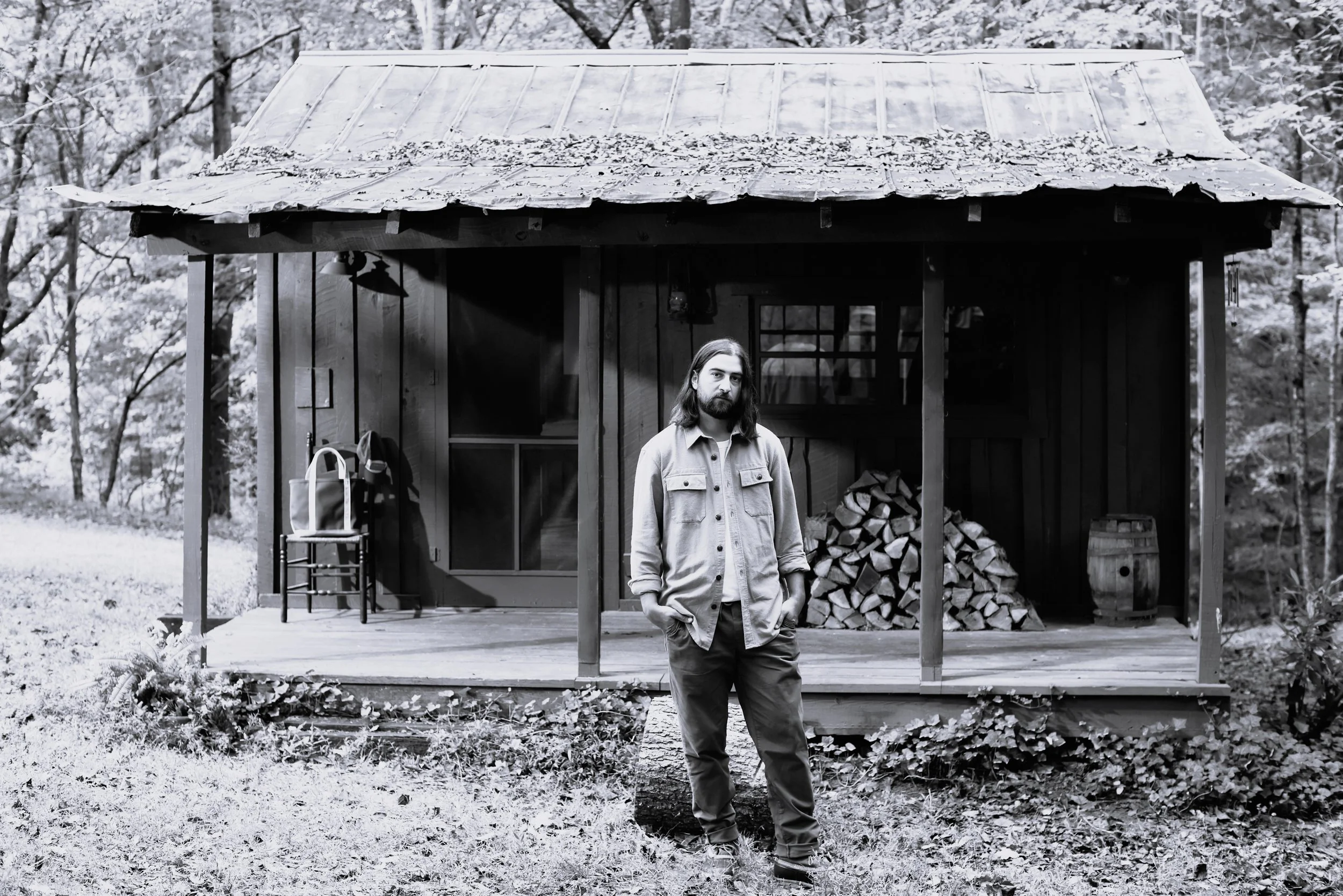 Noah Kahan standing in front of a cabin for L.L.Bean.