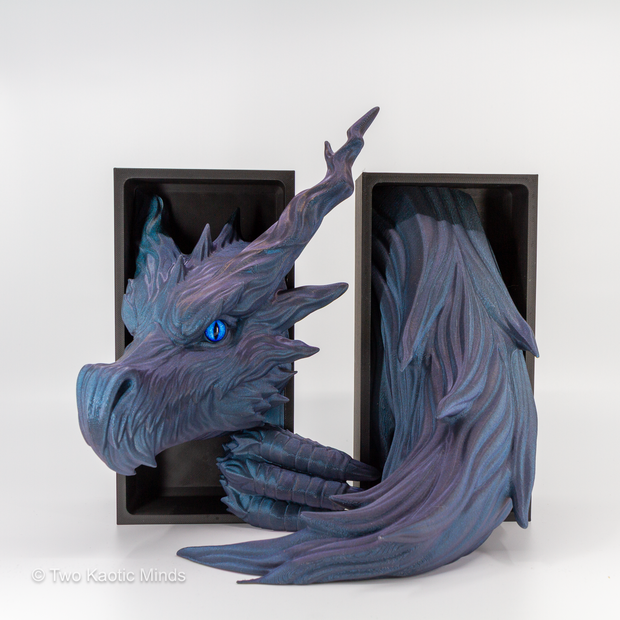 Close front angle of the Shadow Dragon showing Starlight Twilight iridescent PLA, elegant swept horns, flowing feathered scale formations, and blue glass eye