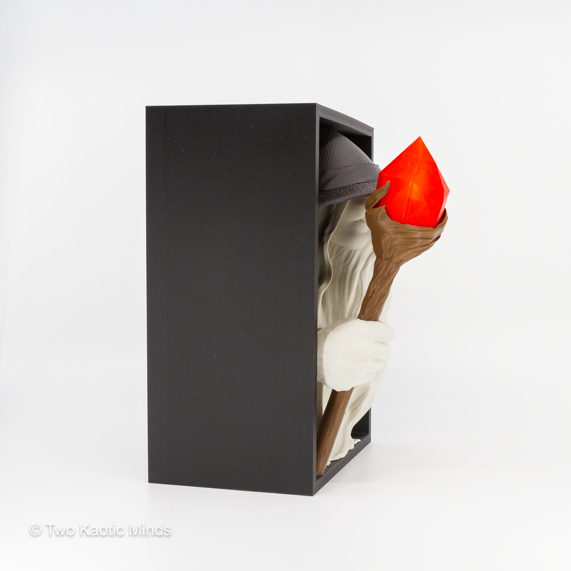 Opposite side angle of the wizard book nook showing matte black box depth and white wizard with glowing amber staff lantern