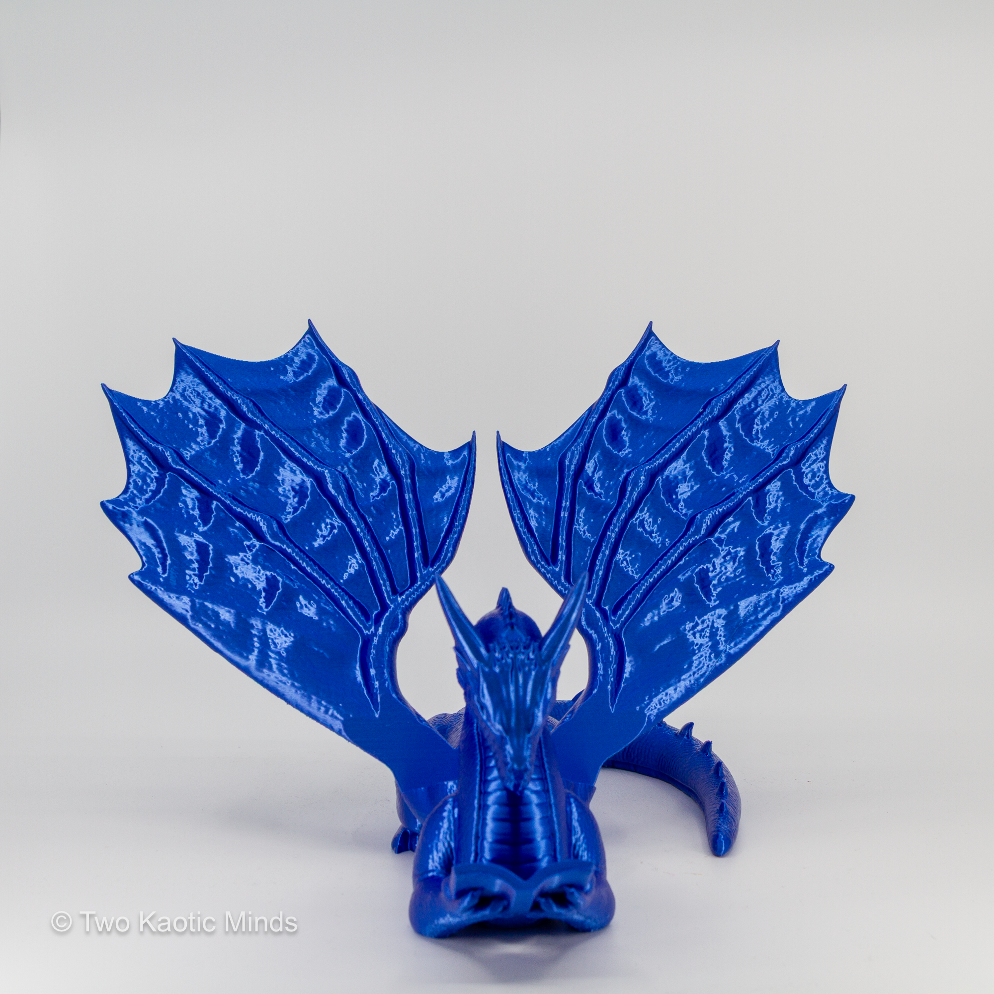 Blue dragon book holder angled left view showing wing detail and crouching dragon pose